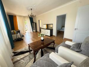 a living room with a couch and a table at Hello Batumi Apartment in Batumi