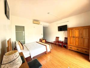 a bedroom with a bed and a tv in it at Venus Phu Quoc Hotel in Phú Quốc