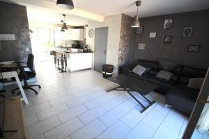 a living room with a couch and a table at Maison - Proche RER - Jusqu'à 6 Personnes in Saint-Michel-sur-Orge
