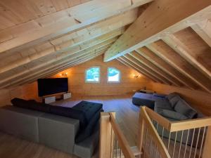 a living room with two couches and a flat screen tv at Casa Bluette in Selma