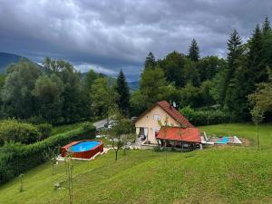 a house with a swimming pool in a field at Holiday House Provance in Brod na Kupi