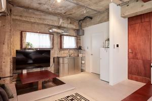 a room with a kitchen and a living room at Koubanoyado in Tokyo