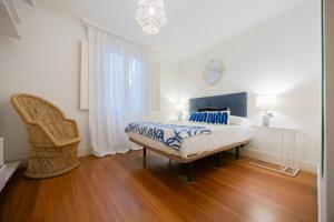 ビルバオにあるZazpikaleak by Staynnapartmentsのベッドと椅子のある白い寝室