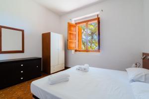 a bedroom with two beds and a window at Villa Santa Anastasia in Matino