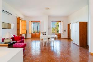 a living room with a red couch and a table at Villa Santa Anastasia in Matino