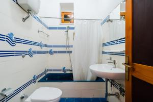 a bathroom with a toilet and a sink at Villa Santa Anastasia in Matino +21 photos