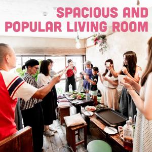 a group of people standing around a table eating food at LovesunshineBackpackers in Tokyo +69 photos