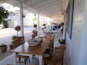 a wooden table and chairs on a patio at Gli Oleandri in Ginosa Marina