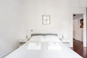 Letto o letti in una camera di La corte di Merlino - Apt centrale di pregio