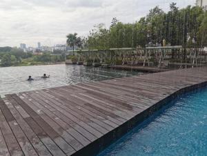 two people swimming in a pool of water at Ryokan AI Japan Friend - Free Hotsprings & Massage in Kuala Lumpur