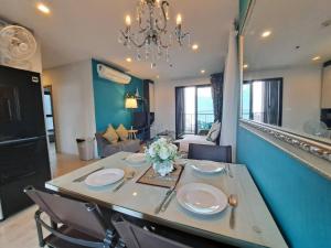 a dining room with a table with chairs and a chandelier at Sea View 2 Bed Room Rare Find Great Location in Pattaya Central