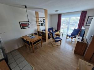 a living room with a table and chairs and a dining room at Fewo-32-Hauke in Orth