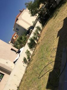 a shadow of a person standing next to a building at Villa tabarka in Tabarka