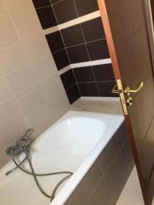 a bathroom with a bath tub with a hose at Villa tabarka in Tabarka