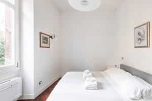 Letto o letti in una camera di La corte di Merlino - Apt centrale di pregio