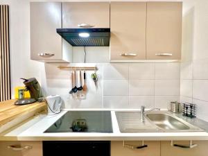a kitchen with a sink and a counter top at Le Logis du Château , Charme au cœur de Sommières in Sommières