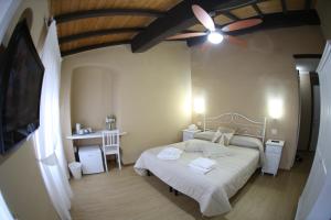 a bedroom with a bed and a ceiling fan at Affittacamere in Piazzetta in Sarzana