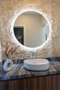 a bathroom with a sink and a mirror at Baja Toscana in Valle de Guadalupe