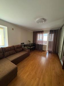 a living room with a couch and a table at Сучасний комфорт та затишок Південне, Южне in Sychavka