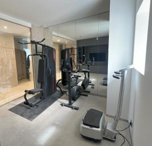 a gym with several exercise bikes and a mirror at Maison Casamande & SPA - Luxe et sérénité dans un domaine d'amandiers in Bouquet