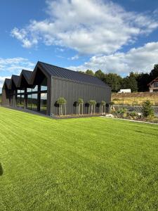 a building with a grass field in front of it at lovNatura in Staniszów