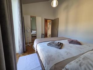 a bedroom with two beds with towels on them at The Lovely Loft in Cres