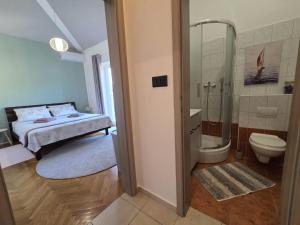 a bathroom with a bed and a shower and a toilet at The Lovely Loft in Cres +11 photos