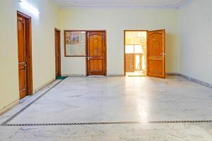 an empty room with doors and a tile floor at FabHotel The Everest 43 in Noida