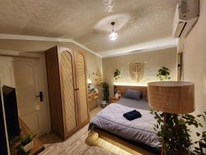 a bedroom with a bed and a television in it at Private rooftop with jacuzzi and pyramids view in ‘Ezbet `Abd el-Ḥamîd