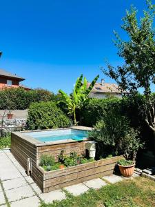 a swimming pool in a garden with plants at Maison familiale au calme in Saint-Félix