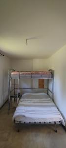 a bedroom with two bunk beds in a room at Maison pleine nature Aiguebellette et Bourget in Loisieux