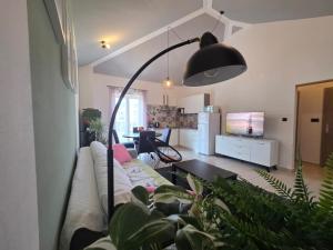 a living room with a couch and a table at The Lovely Loft in Cres