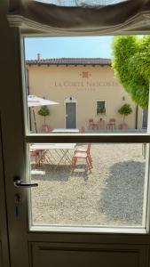 a view of a building through a door at La Corte Nascosta Volpedo in Volpedo