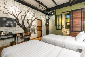 two beds in a room with a brick wall at Sea Crest by Jomtien in Jomtien Beach