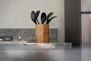 a wooden knife block with utensils in a kitchen at Villas Baja Toscana de Rancho Olivares in Ensenada