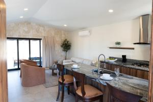 a kitchen and living room with a large counter top at Villas Baja Toscana de Rancho Olivares in Ensenada +29 photos