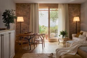 a living room with a couch and a table and a window at La Garriga de Castelladral in Castelladral +115 photos