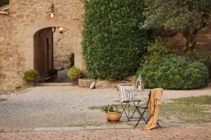 a table and a chair with a kettle on it at La Garriga de Castelladral in Castelladral