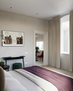 a bedroom with a bed and a desk in it at Villa & Hotel Am Park in Reichenbach im Vogtland
