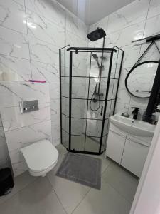 a bathroom with a shower and a toilet and a sink at Apartamenty Anielski Sen 3 in Świeradów-Zdrój +14 photos