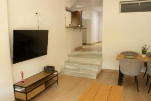 a living room with a flat screen tv on a wall at Gaviotas Playa in Almerimar