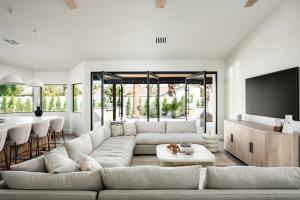a living room with a large couch and a table at The MYAH by Porter NEWLY REMODELED Enjoy the Pool Firepit Luxury in Phoenix