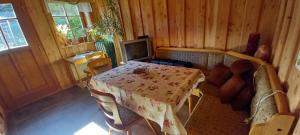 a dining room with a table and a tv at Gästezimmer Morgenstern in Lohmen