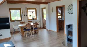 a dining room and living room with a table and chairs at Ferienwohnung Hennrich in Weilbach