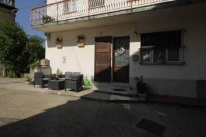 a building with chairs and a porch with a balcony at Appartamento All'Ombra del Castello affitto breve in Levizzano Rangone