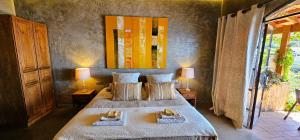 a bedroom with two beds with towels on them at Les Terrasses Suites in Calheta +25 photos