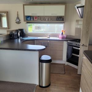 a kitchen with a sink and a counter top at 125 Maple Lake Southview Caravan Park in Winthorpe