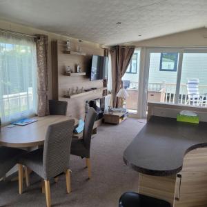 a living room with a table and chairs and a dining room at 125 Maple Lake Southview Caravan Park in Winthorpe