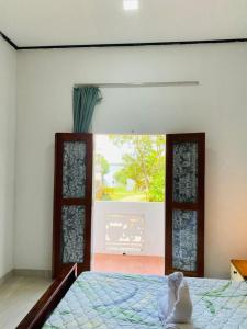 a stuffed animal sitting on a bed in a bedroom at Viyan hotel in Negombo
