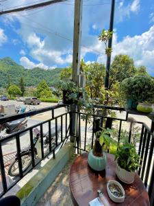 a table on a balcony with a view of a street at Flaco Hostel - Trekking, Tour, Bus ticket in Sa Pa
